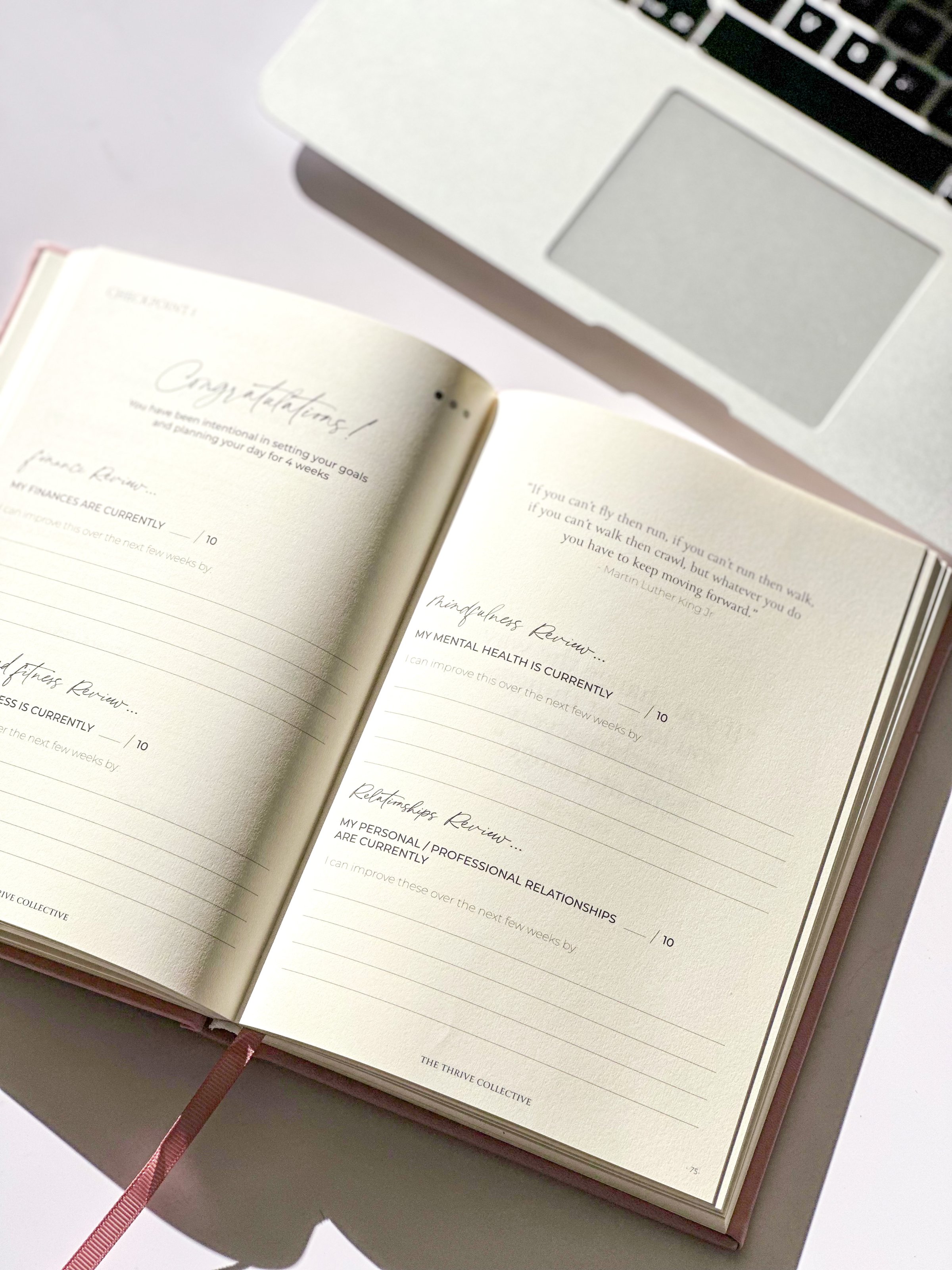 An open notebook with handwritten notes, placed beside a laptop. The sunlight casts a warm glow on the pages.