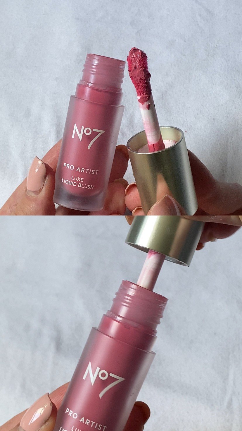 A hand holding a tube of No7 Pro Artist Luxe Liquid Blush with the applicator exposed, showcasing its pink color.