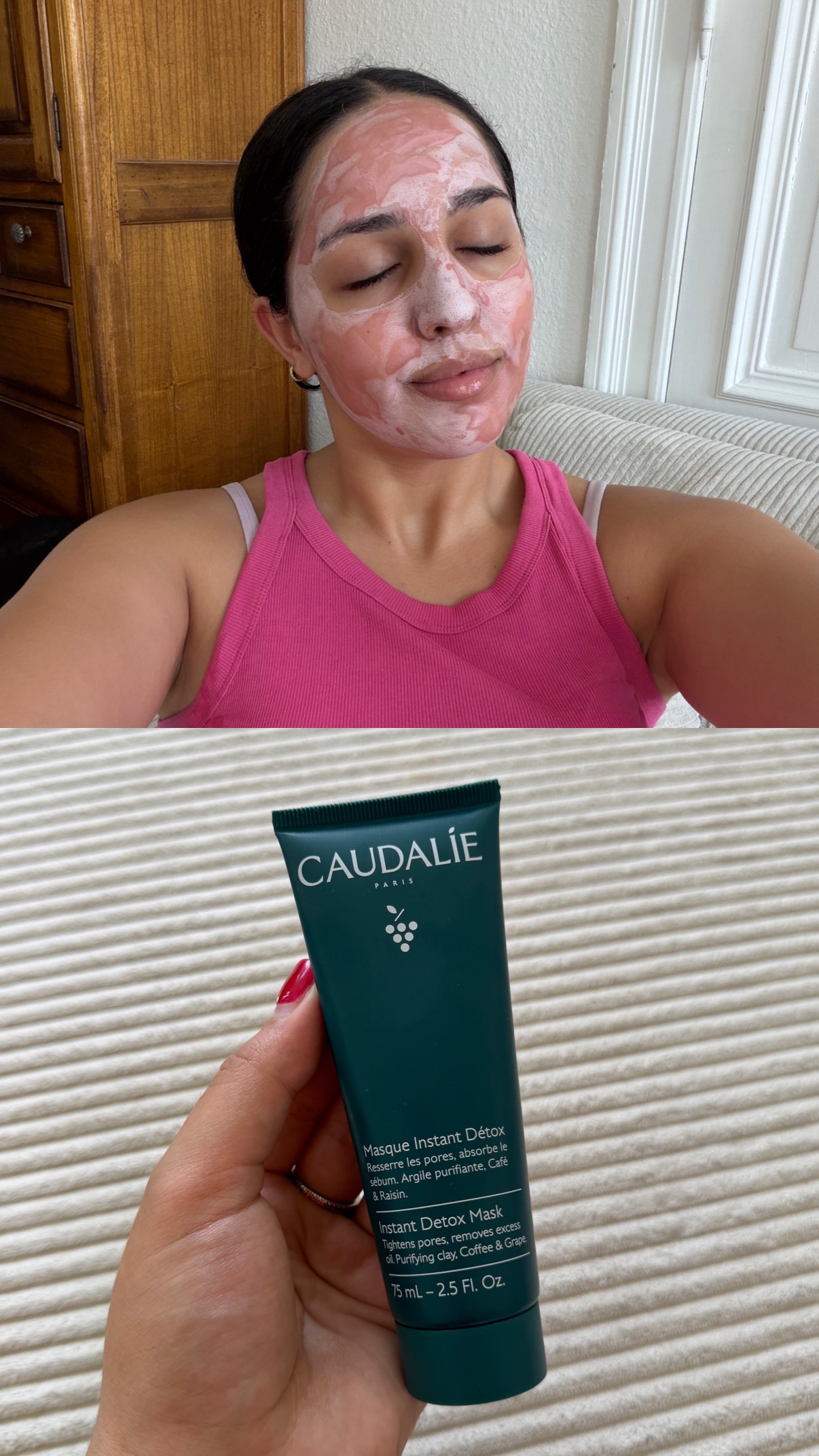 A person with a facial mask on their face is relaxing on a couch, while holding a tube of Caudalie Instant Detox Mask in their hand.